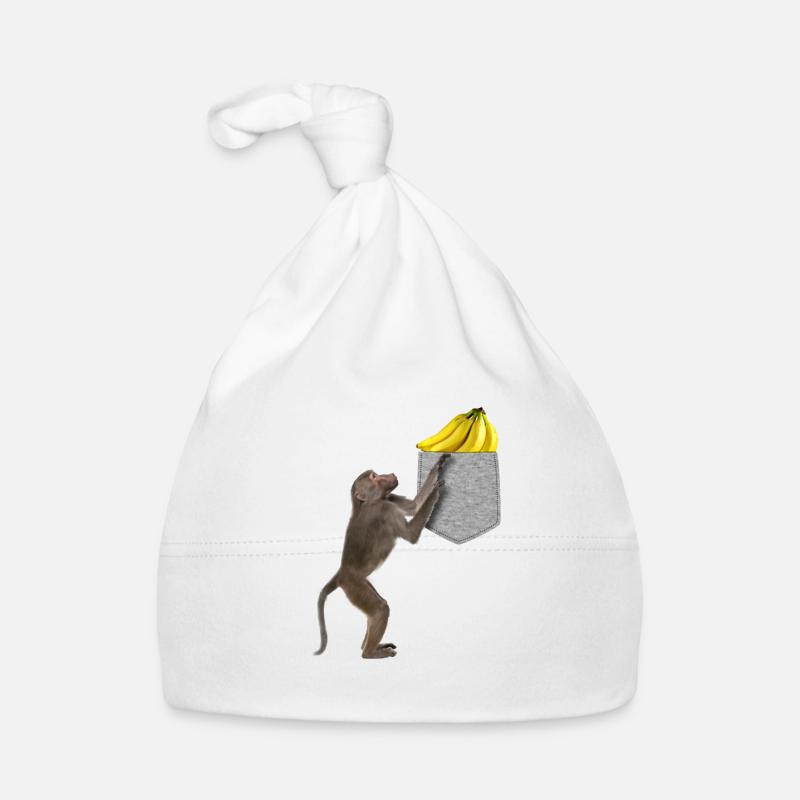 Pavian-Affe, der nach Banane in falscher Tasche greift Baby Bio-Mütze