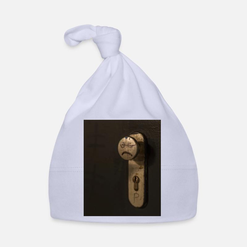 A doorknob with a bad tempered face painted on it Organic Baby Cap