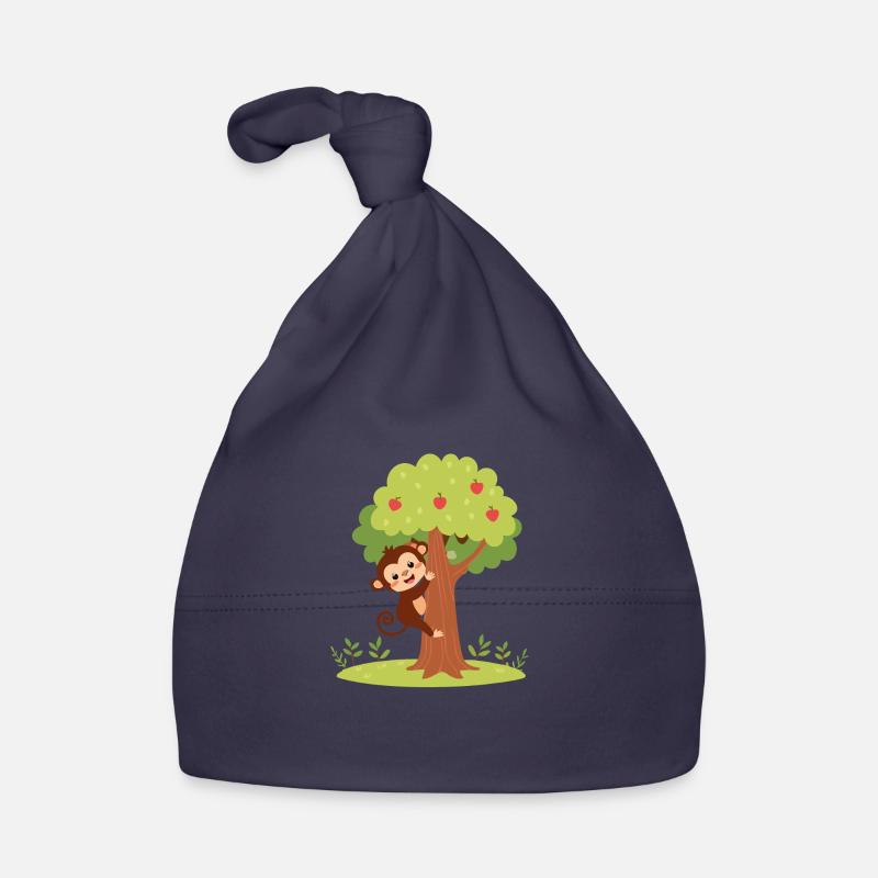 Singe mignon grimpant à un arbre Bonnet bio Bébé