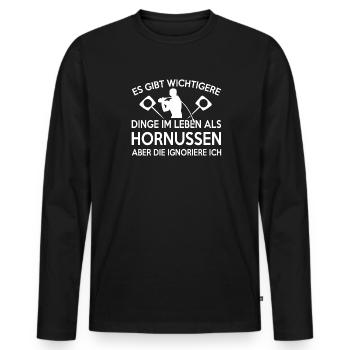 Es gibt wichtigeres als Hornussen - Männer Premium Bio Langarmshirt - Schwarz - Vorne - Nico (187cm)