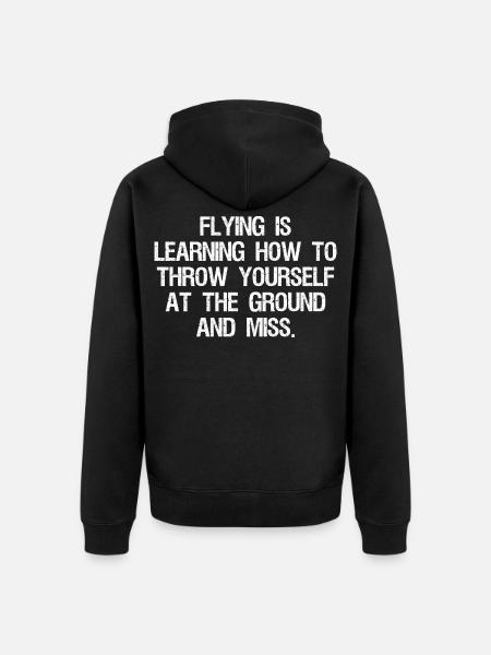 flying is learning how to throw yourself at the - Unisex Premium Organic Zip Hoodie - black