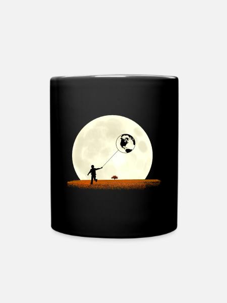 Boy on meadow pulls earth in front of moon - Full Colour Mug - black
