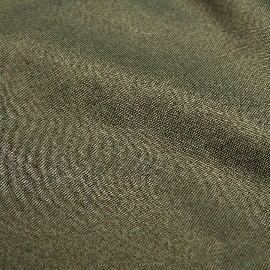 Kraken Island badge on a men's slim fit t-shirt, khaki green, close-up